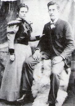A sepia-toned portrait of Charles Hubbard Sanders and Sadie Jane Stinnett Sanders, seated together for a formal photograph.